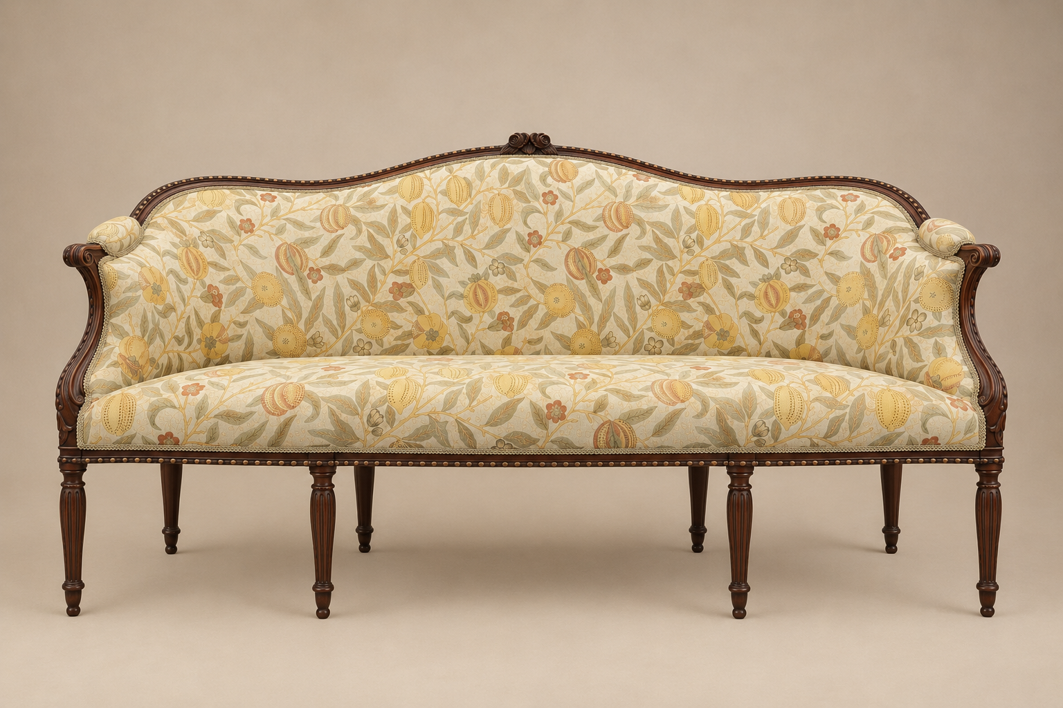 Georgian sofa with carved dark wood frame and fluted legs, reupholstered in a cream, sage and ochre botanical fruit-patterned fabric with brass nailhead trim