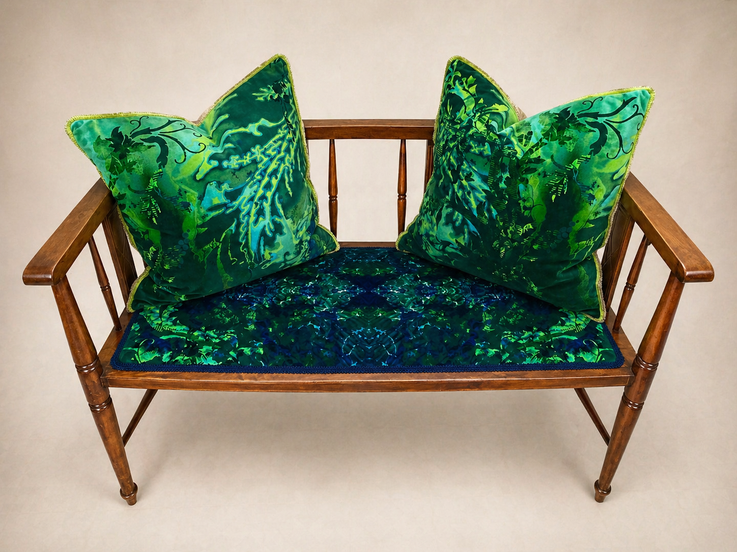Spindle-back bench with emerald velvet seat and cushions