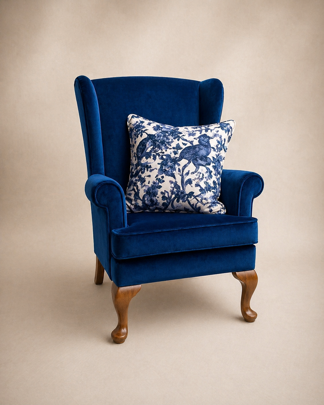 Wingback chair in deep navy velvet with chinoiserie cushion